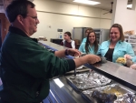 group of employees serving food to a customer