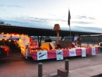 Adults and kids on a Christmas Story parade float in Quanah